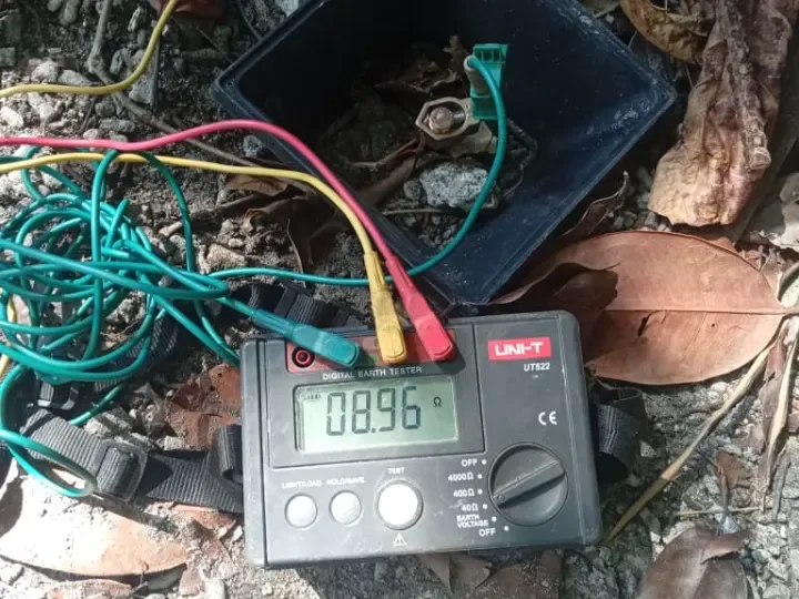 Digital earth resistance tester connected to an earth electrode pit during a site test